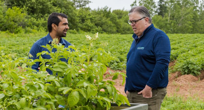 Dr. Farooque speaking with Environment, Energy and Climate Action Minister Steven Myers on agricultural research related to climate change  